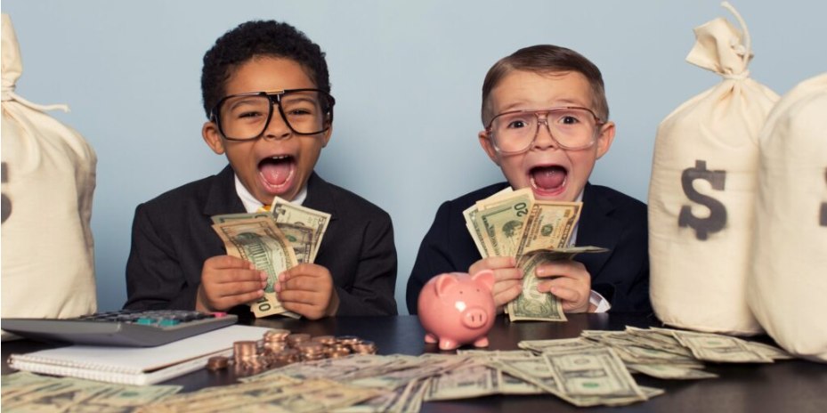 Two kids in suits celebrating with cash and a piggy bank